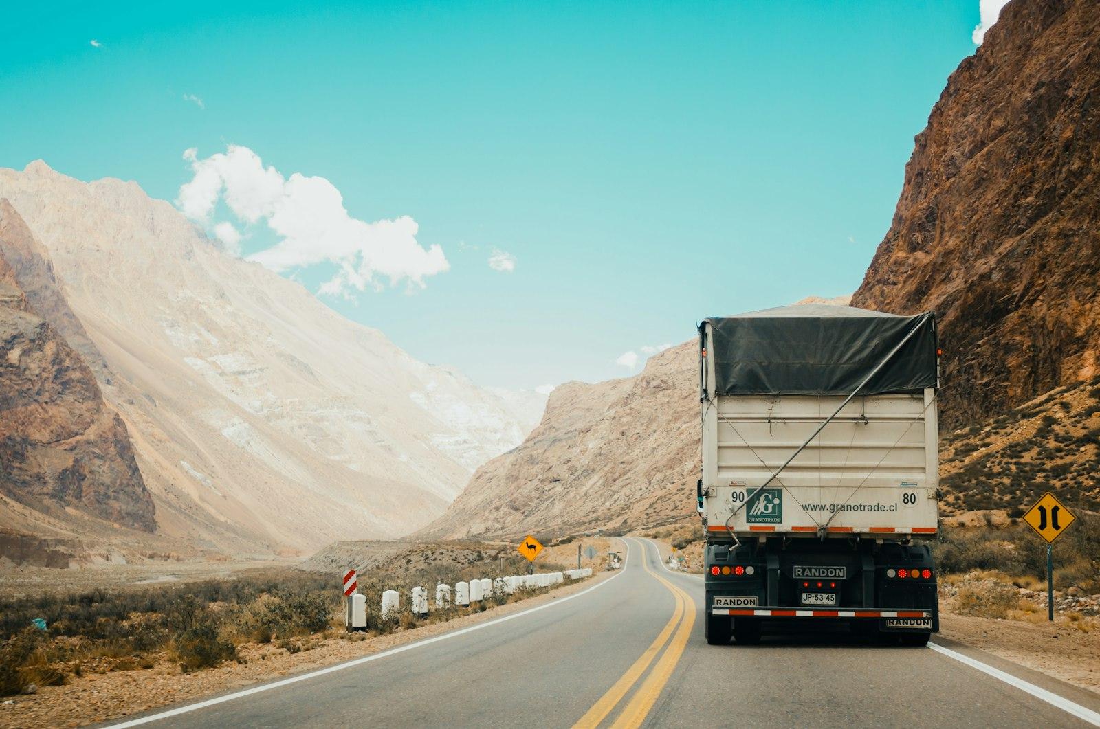 Trucks on an expressway through mountains