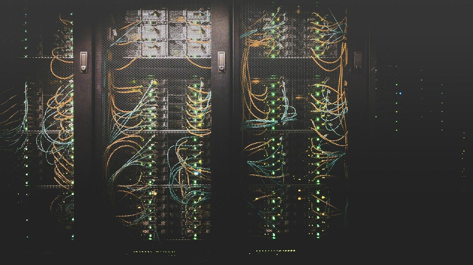 Rows of cabled server racks in a data center