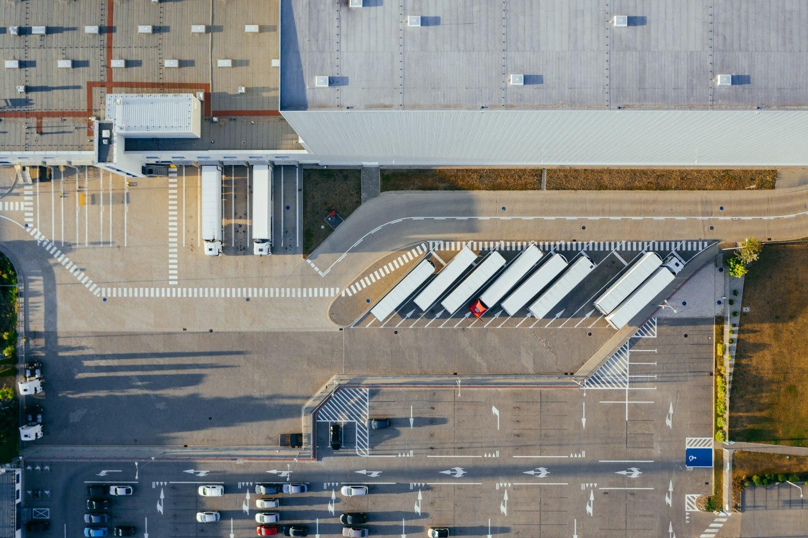 Aerial view of a logistics center with trucks loading goods