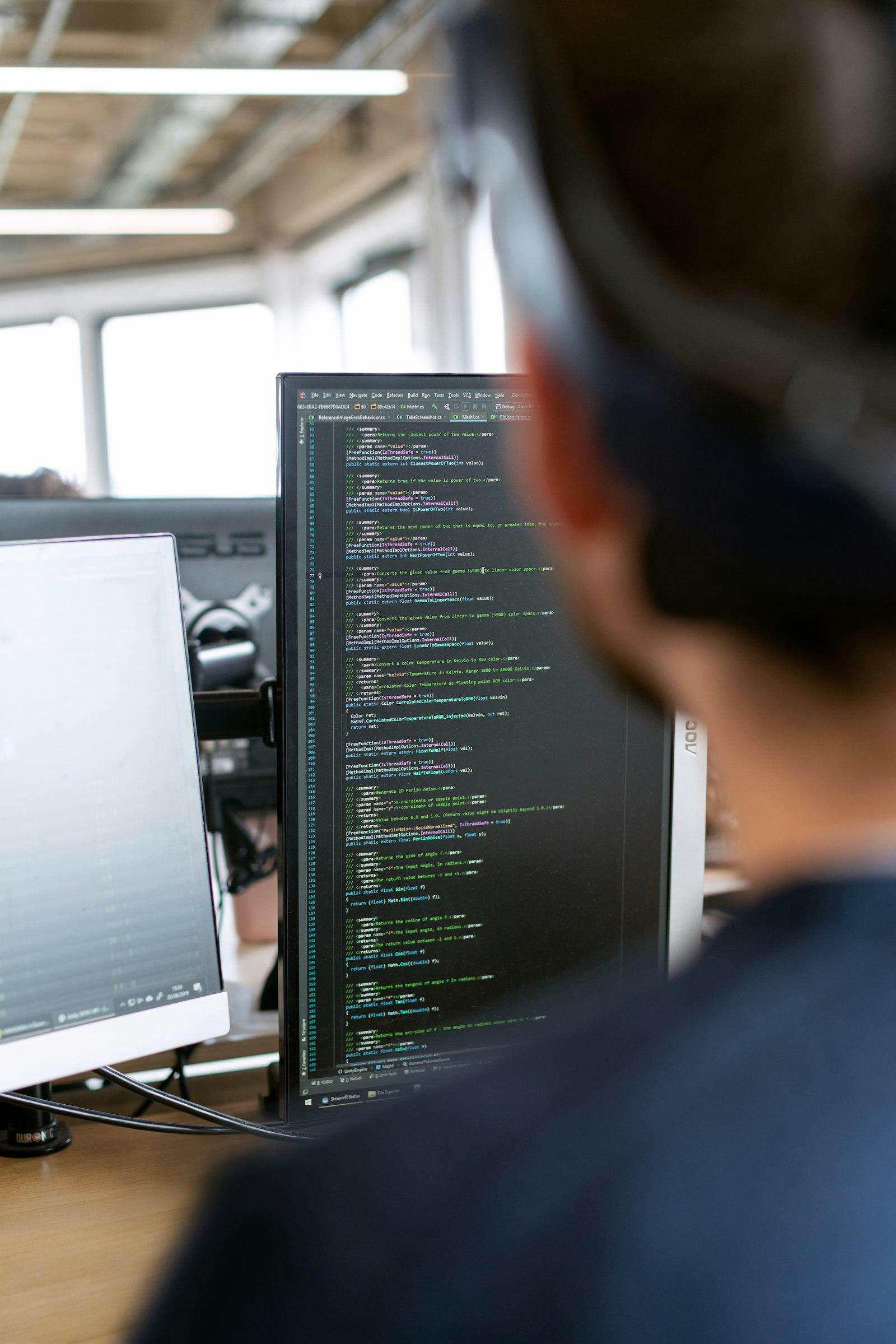 Developer working in front of a source-code screen
